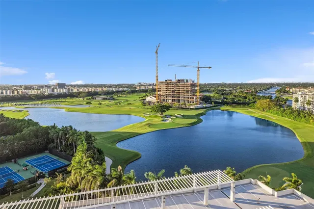 a view of a balcony with furniture and floor to ceiling window