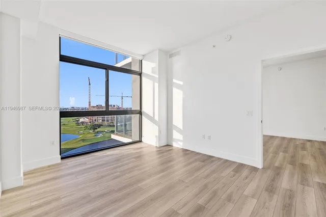a view of a room with wooden floor