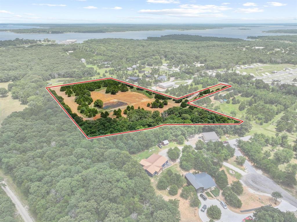 1445 Cedar Mills Road Gordonville, TX 76245 - Photo 11 of 28 Expansive land parcel featuring a visible pond, mature trees, and open fields