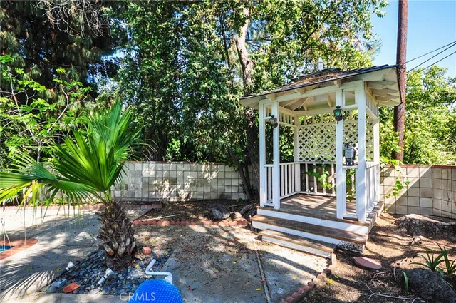 a view of a house with a tree in front of it
