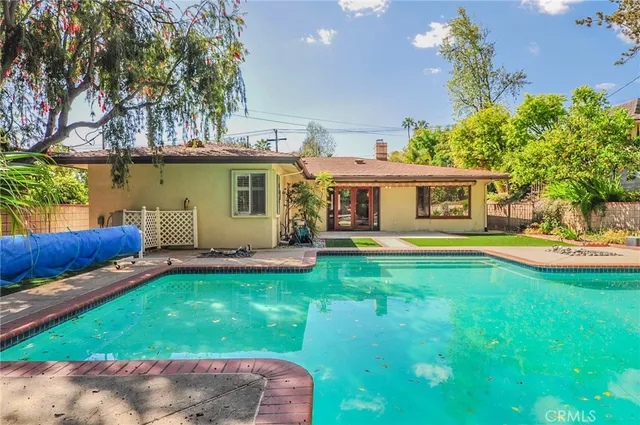 a view of a house with swimming pool yard and patio