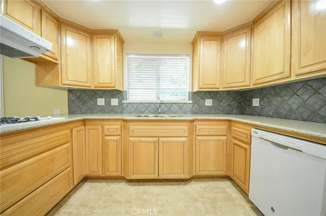 a kitchen with granite countertop cabinets and window