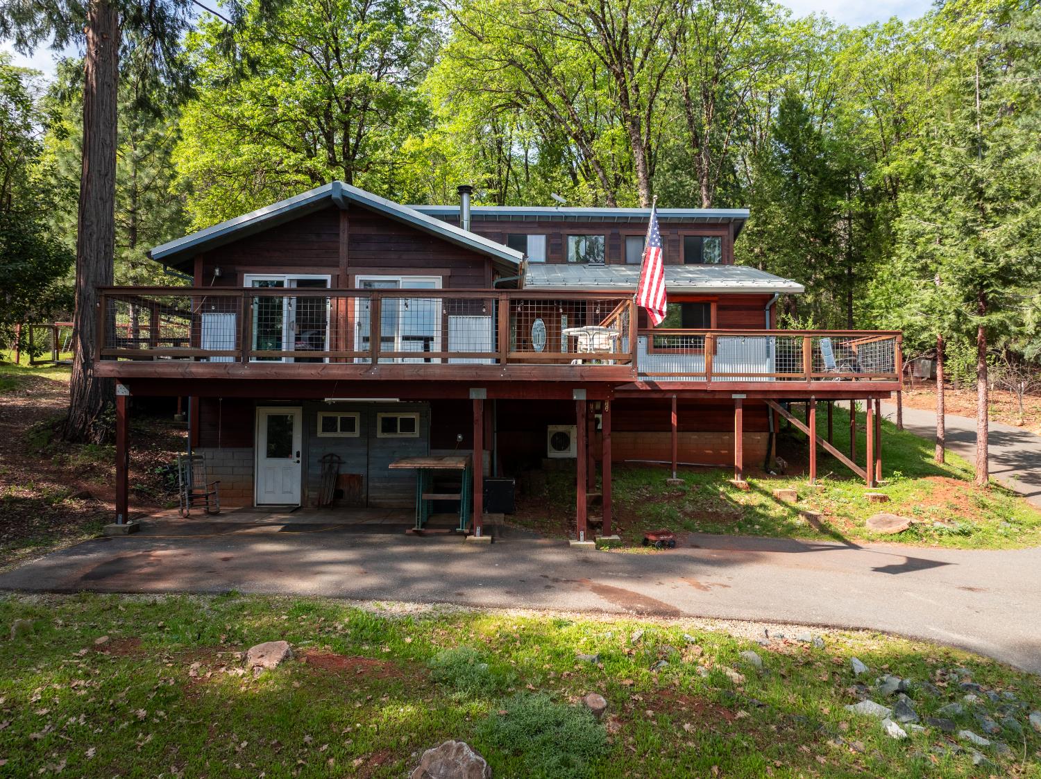 a view of a house with a wooden deck and a yard