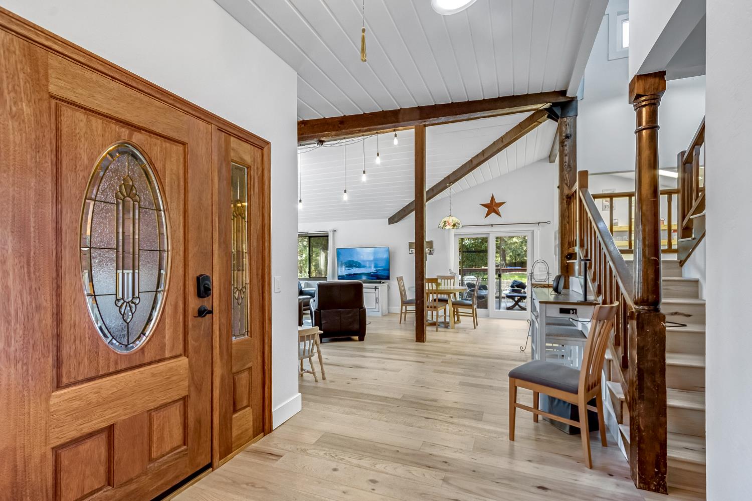 12081 Robust Way Nevada City, CA 95959 - Photo 4 of 39 a living room with furniture a large window and wooden floor