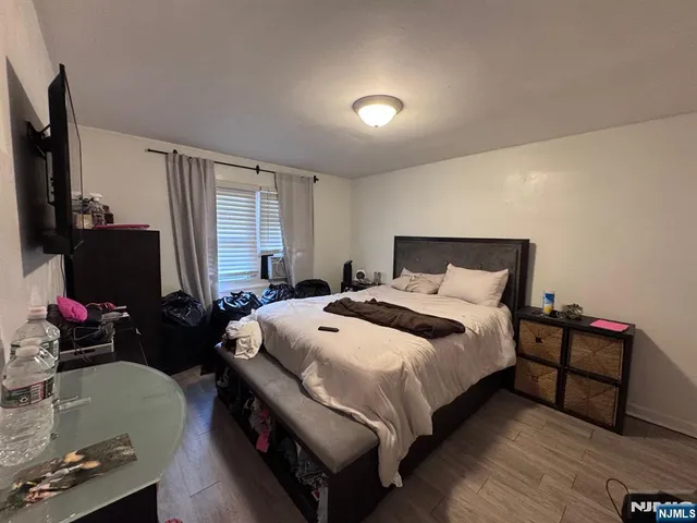 a bedroom with a bed and a flat tv screen