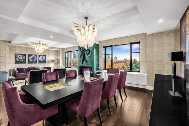 a living room with furniture chandelier and a large window