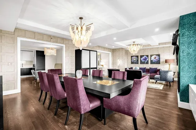 a view of a dining room with furniture a chandelier and wooden floor