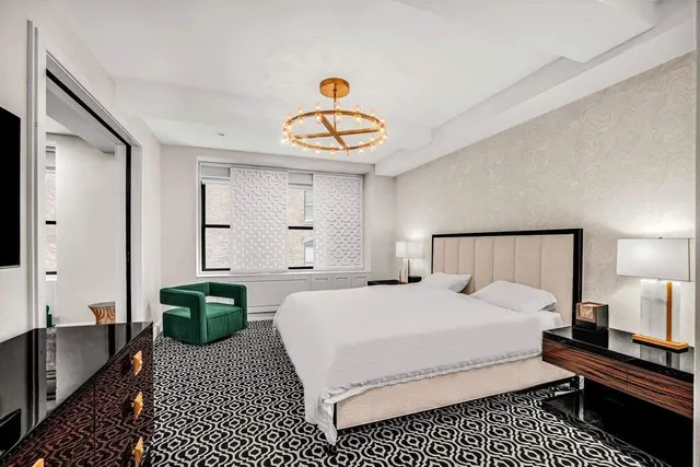 a kitchen with stainless steel appliances a dining table chairs and chandelier