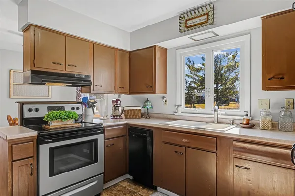 a kitchen with a sink stove and microwave