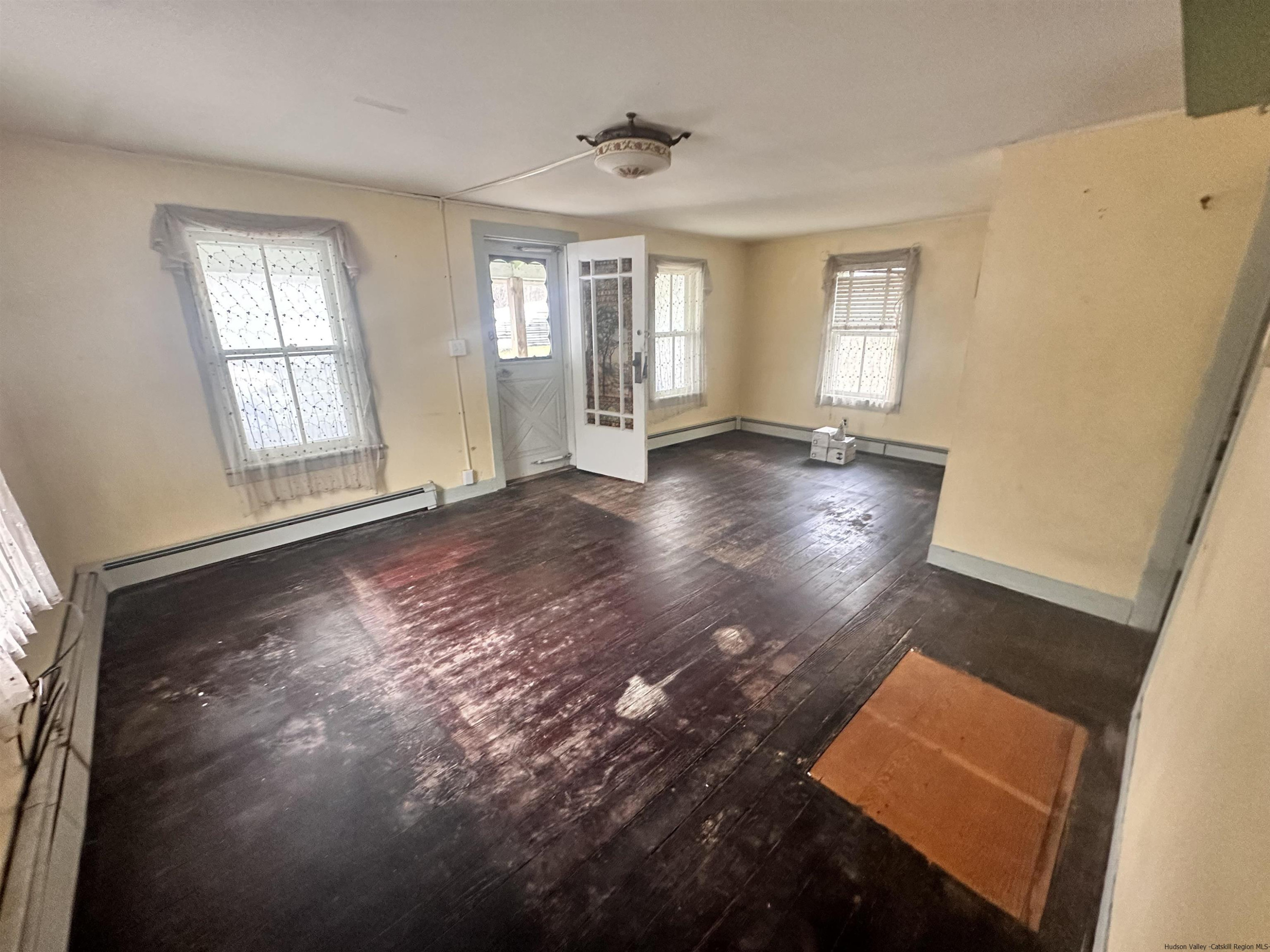 258 North Lake Road Haines Falls, NY 12436 - Photo 2 of 12 a view of an empty room with wooden floor and a window