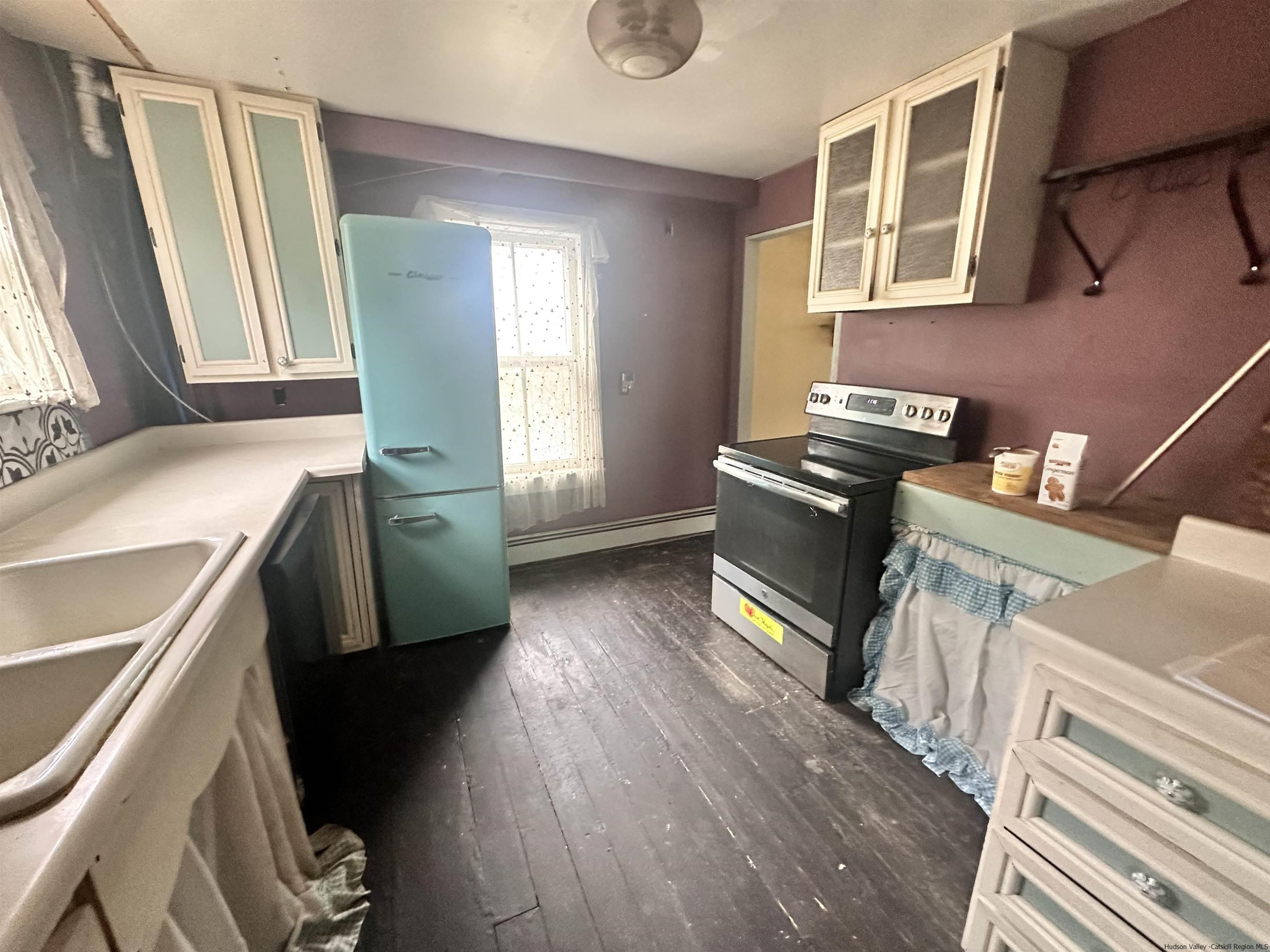 258 North Lake Road Haines Falls, NY 12436 - Photo 3 of 12 a kitchen with granite countertop a stove a sink and wooden floor