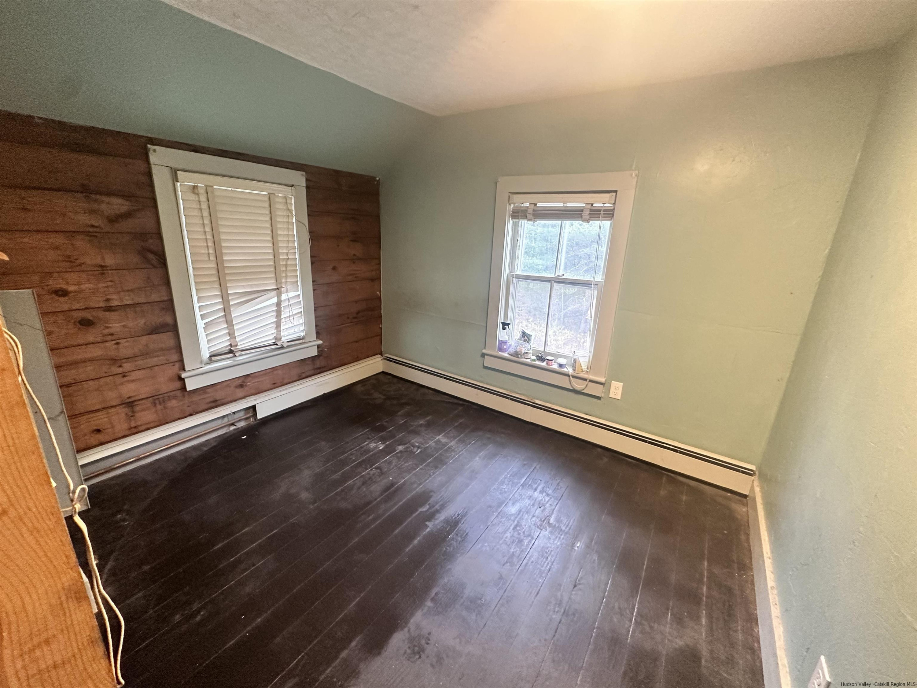 258 North Lake Road Haines Falls, NY 12436 - Photo 5 of 12 an empty room with wooden floor and windows