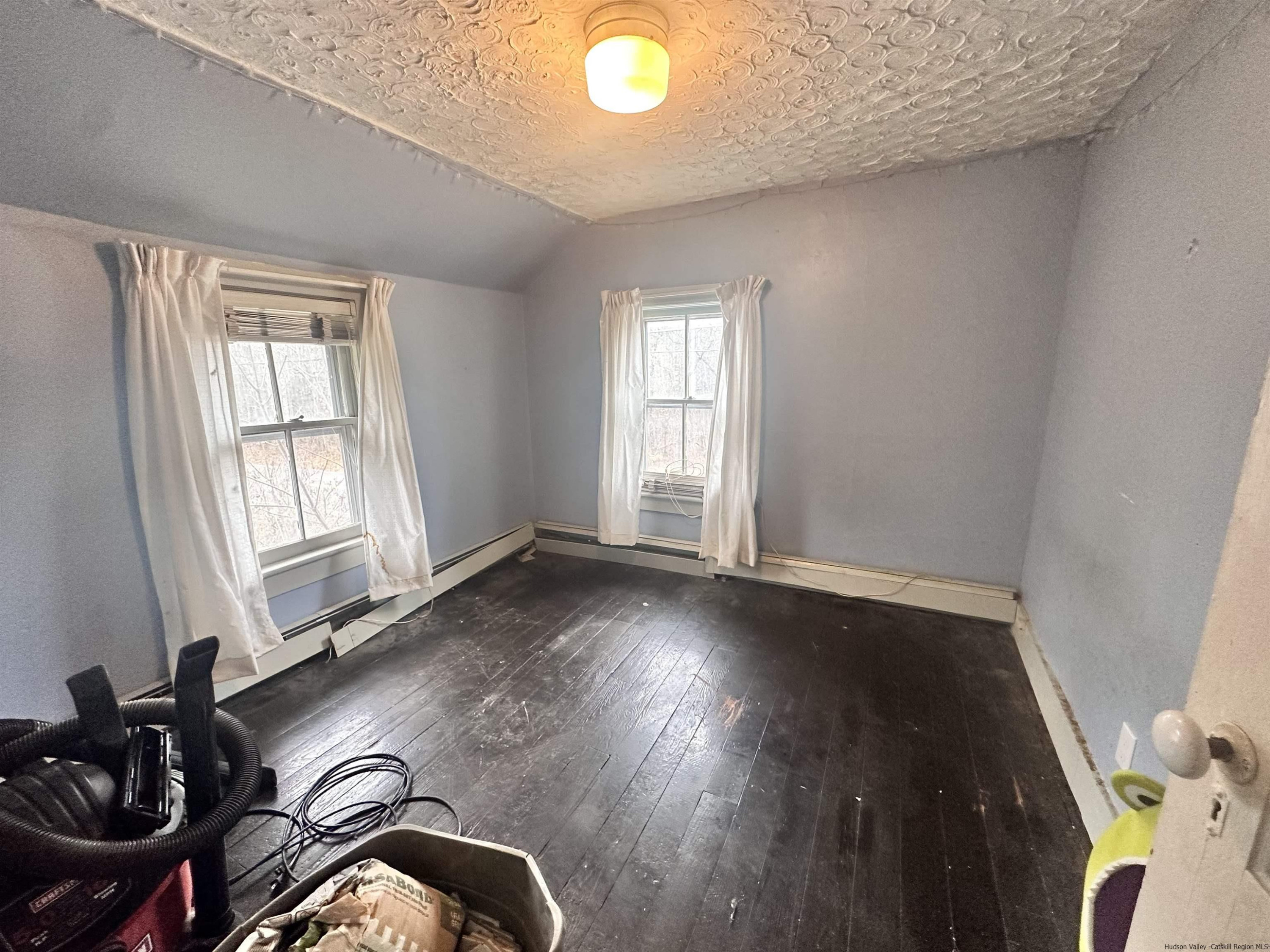 258 North Lake Road Haines Falls, NY 12436 - Photo 8 of 12 an empty room with wooden floor and windows
