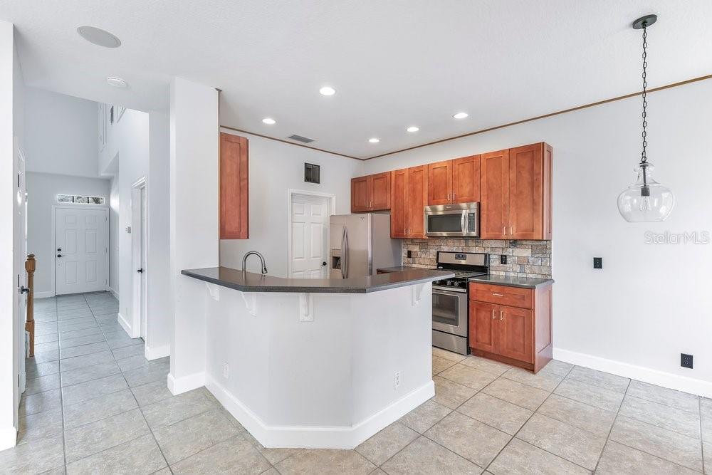 125 Manor View Lane DeLand, FL 32724 - Photo 12 of 37 a kitchen with stainless steel appliances granite countertop a refrigerator and a sink