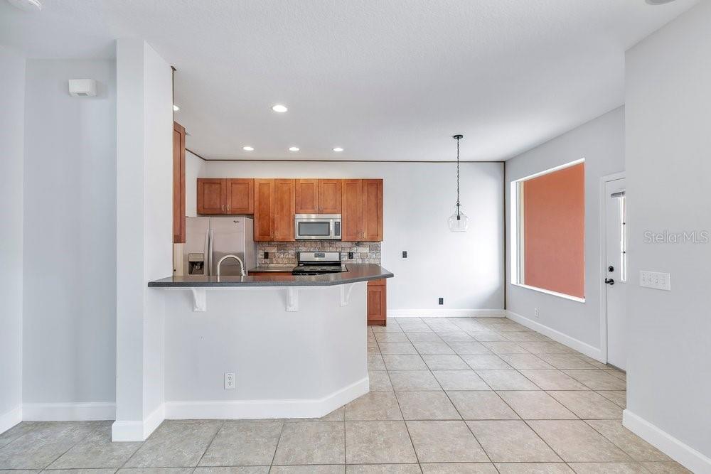 125 Manor View Lane DeLand, FL 32724 - Photo 13 of 37 a kitchen with stainless steel appliances a refrigerator and a stove top oven