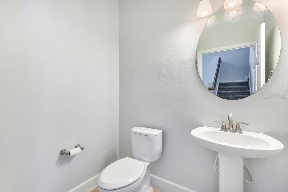 125 Manor View Lane DeLand, FL 32724 - Photo 14 of 37 a bathroom with a toilet a sink and mirror