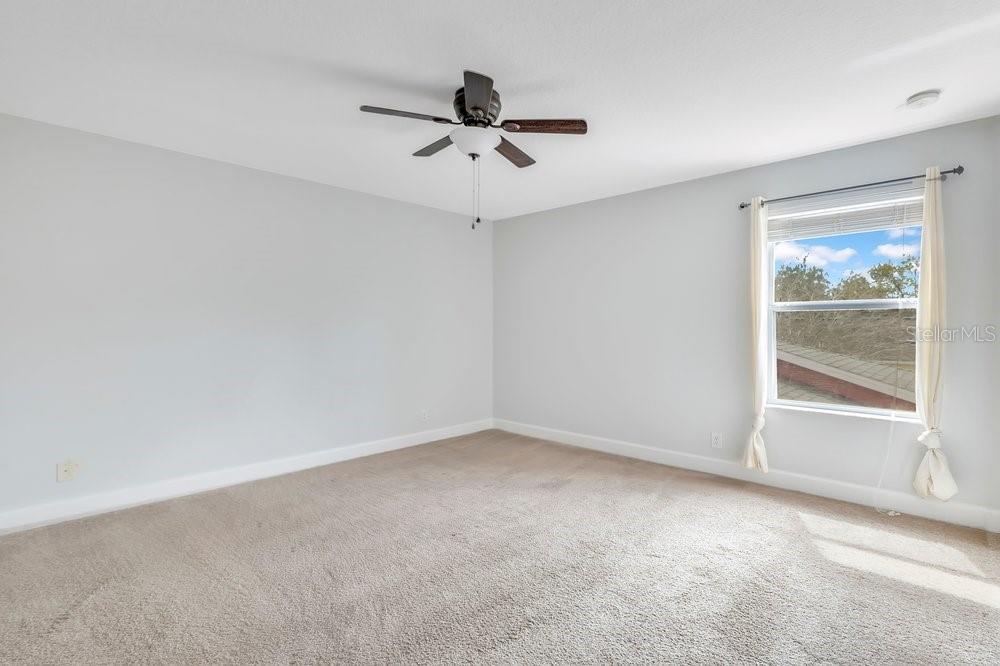 125 Manor View Lane DeLand, FL 32724 - Photo 15 of 37 an empty room with a window and a ceiling fan