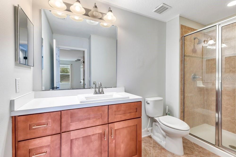125 Manor View Lane DeLand, FL 32724 - Photo 17 of 37 a bathroom with a sink a toilet a mirror and shower