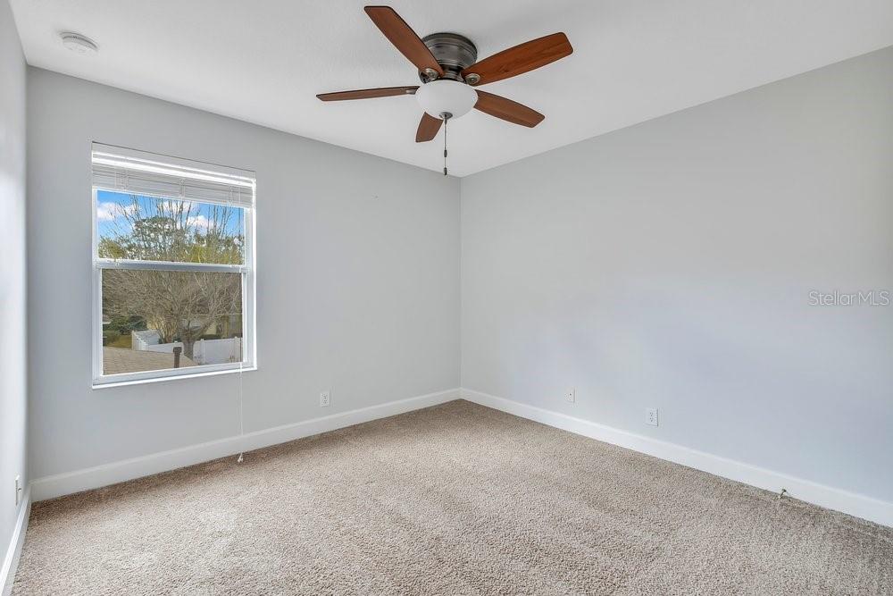 125 Manor View Lane DeLand, FL 32724 - Photo 19 of 37 an empty room with a window and a ceiling fan
