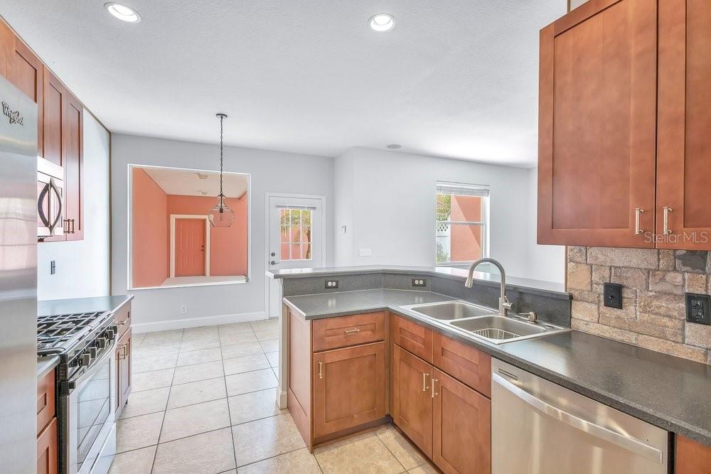 125 Manor View Lane DeLand, FL 32724 - Photo 10 of 37 a kitchen with a sink stove and cabinets