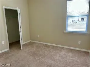 an empty room with a empty space and windows