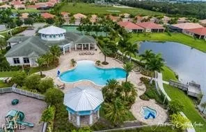 an aerial view of a house with swimming pool outdoor seating and yard