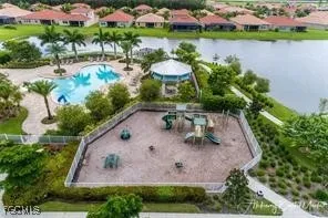 an aerial view of a house with a yard and lake