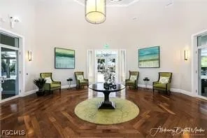 a living room with furniture and a chandelier