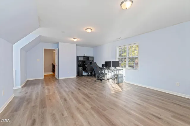 a view of a workspace with furniture and a window