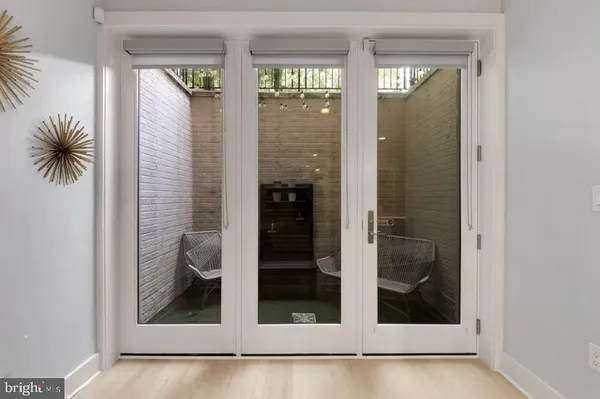 a view of a hallway with wooden floor and a window