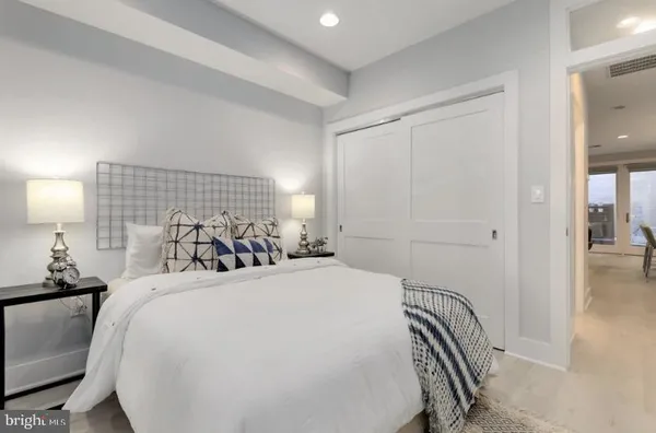 a bedroom with a bed and a lamp