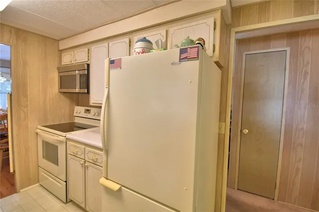 a white refrigerator freezer sitting inside of a kitchen