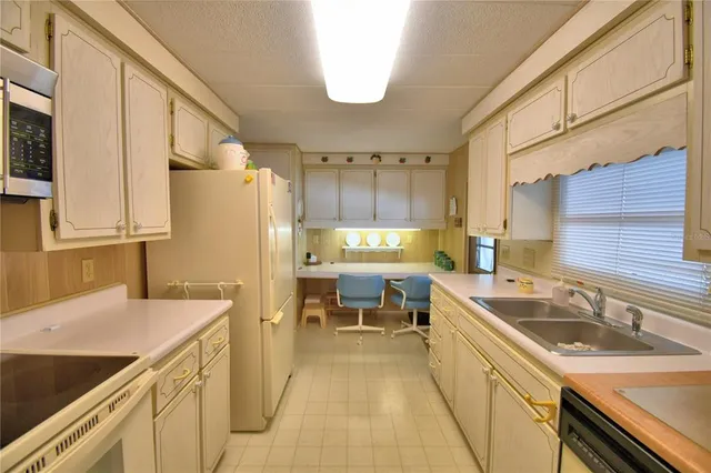 a kitchen that has a sink and a stove in it