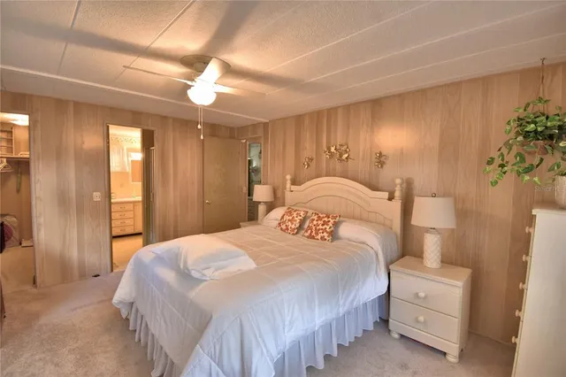 a bedroom with a large bed and a chandelier