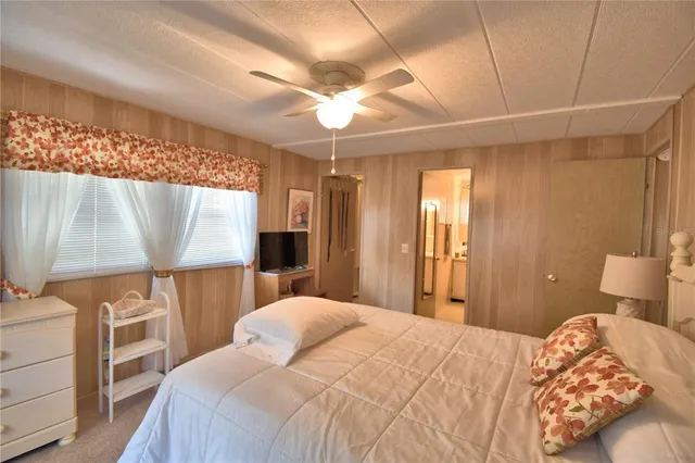 a bedroom with a bed and a flat tv screen