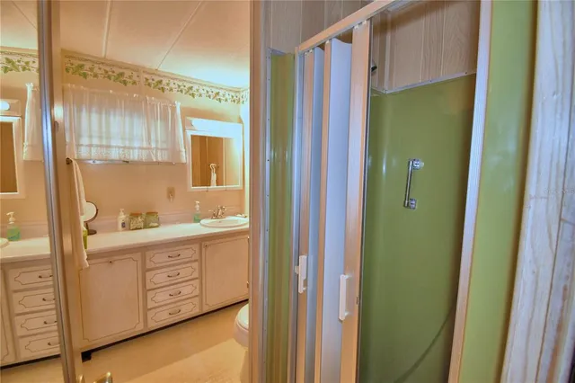 a bathroom with a double vanity sink and a mirror
