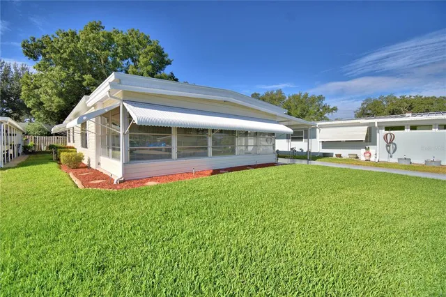 a view of a house with a backyard porch and sitting area