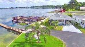 a view of a lake with a yard and a large bridge