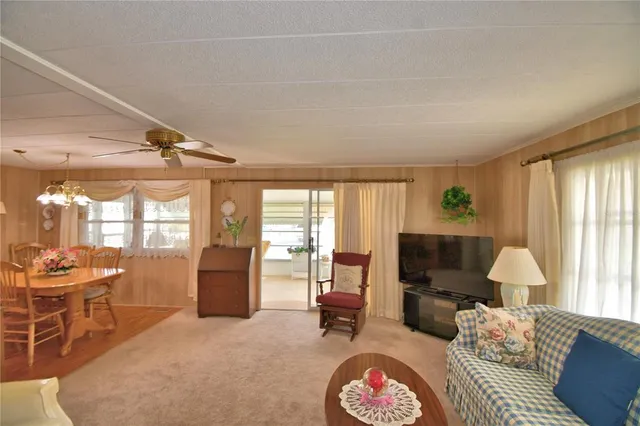 a living room with furniture a large window and a flat screen tv