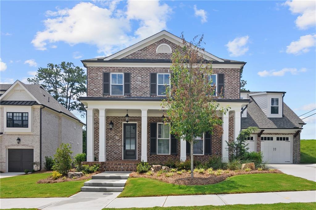 10025 Ruppel Lane Johns Creek, GA 30005 - Photo 1 of 23 a front view of a house with a yard and garage