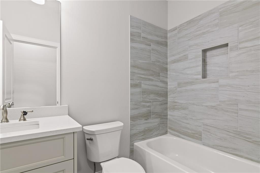 10025 Ruppel Lane Johns Creek, GA 30005 - Photo 22 of 23 a bathroom with a sink a toilet and shower