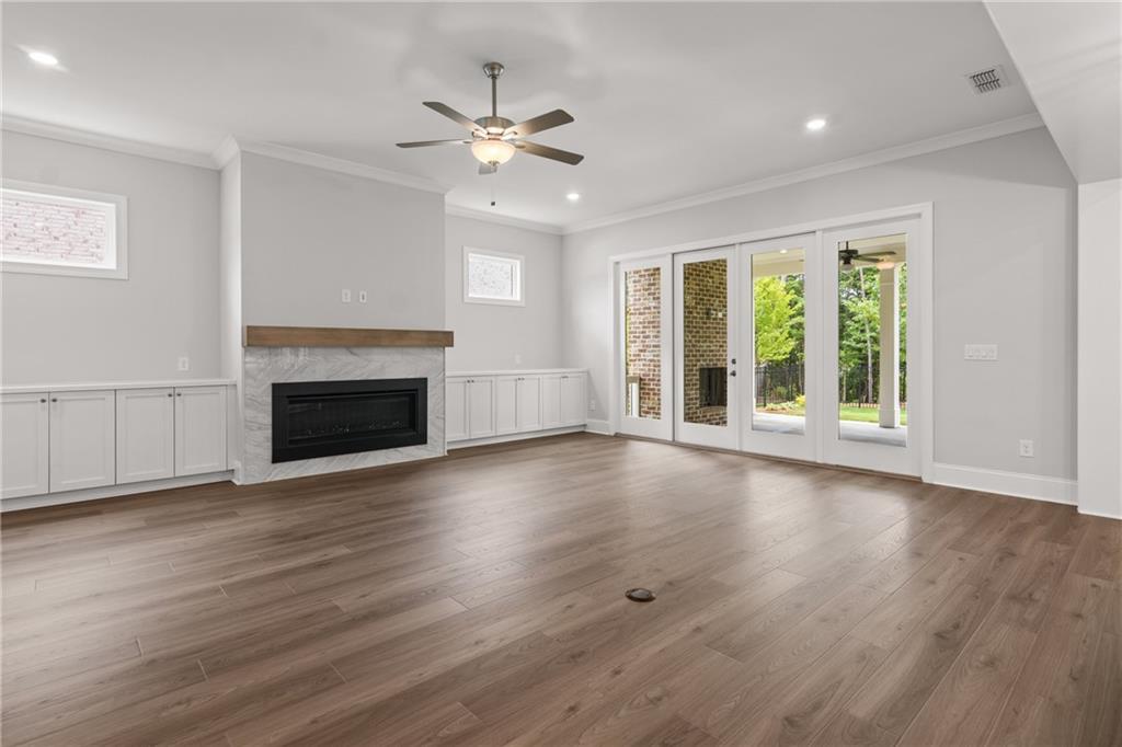 10025 Ruppel Lane Johns Creek, GA 30005 - Photo 3 of 23 a view of an empty room with wooden floor and a window