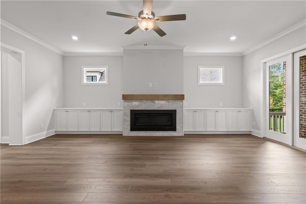10025 Ruppel Lane Johns Creek, GA 30005 - Photo 4 of 23 a view of empty room with wooden floor and fireplace