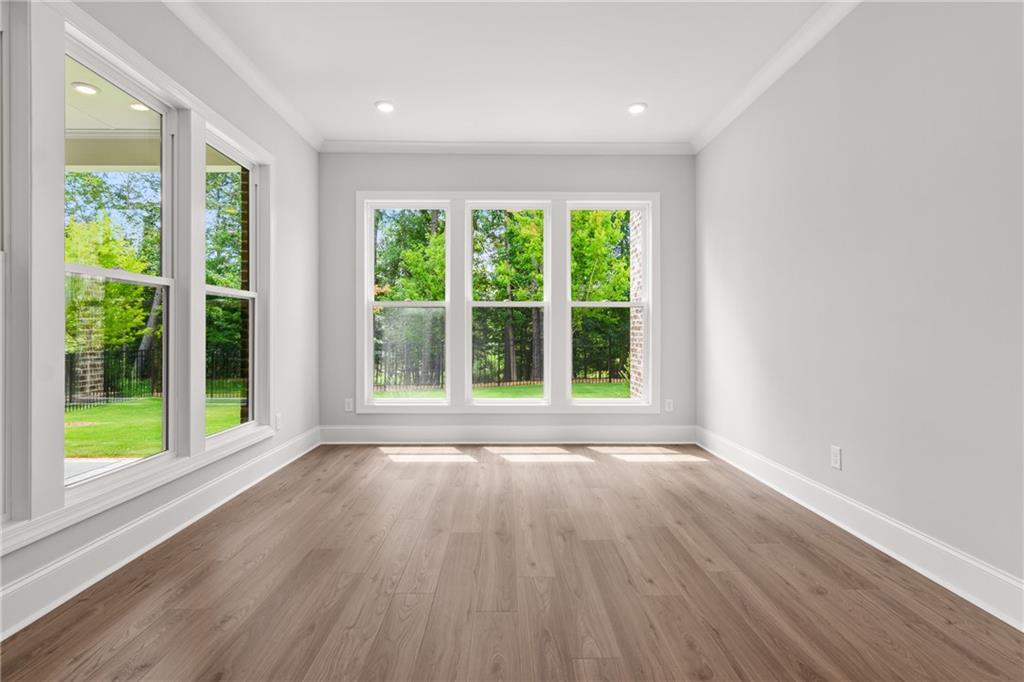 10025 Ruppel Lane Johns Creek, GA 30005 - Photo 7 of 23 a view of an empty room with wooden floor and a window