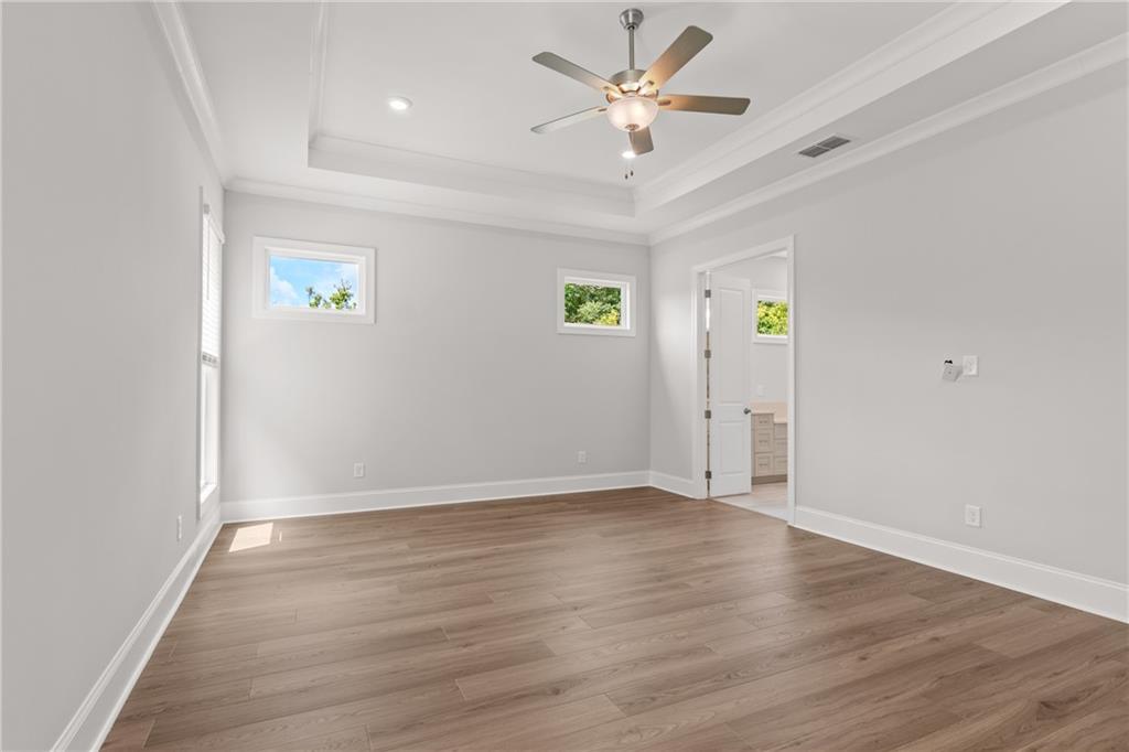 10025 Ruppel Lane Johns Creek, GA 30005 - Photo 9 of 23 an empty room with wooden floor and ceiling fan