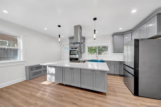a kitchen with stainless steel appliances a stove top oven and a refrigerator