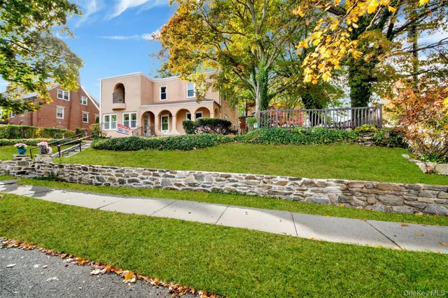a front view of a house with a garden