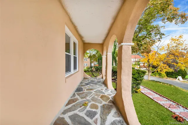 a view of a small yard with a large tree