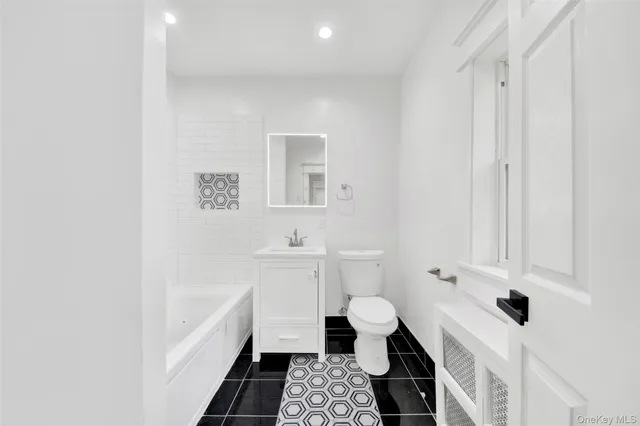 a bathroom with a sink a toilet and a bathtub