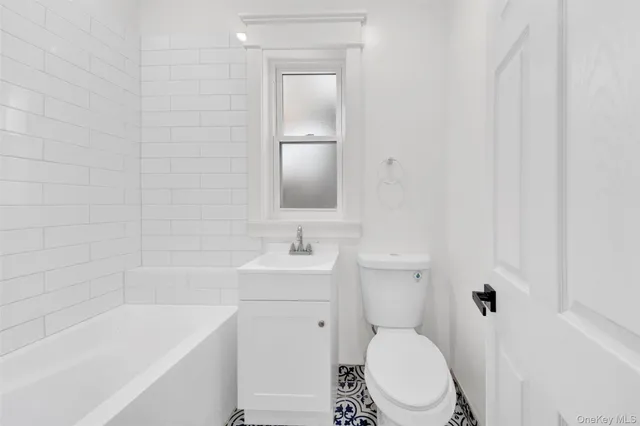 a bathroom with a toilet a sink and bathtub